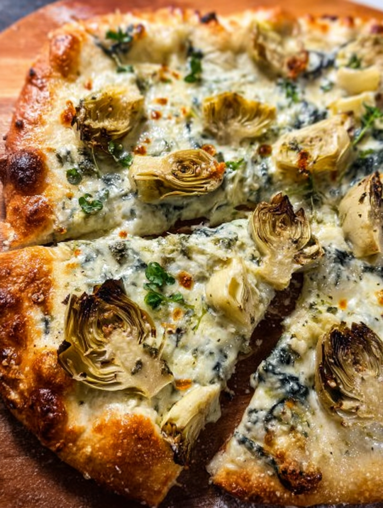 Artichoke pizza with spinach parmesan cream sauce