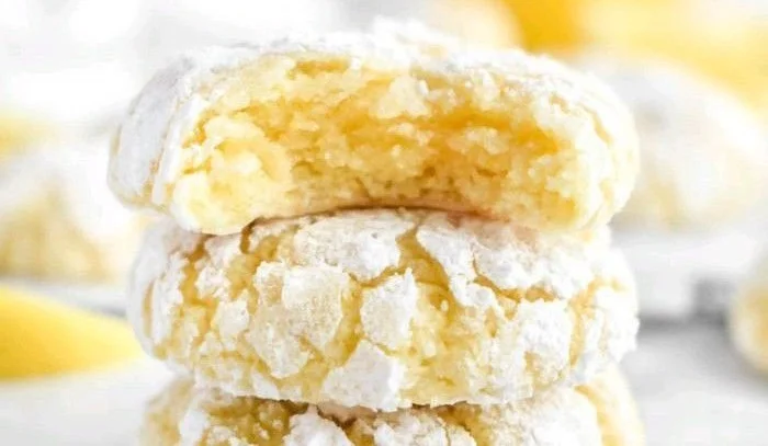 Freshly baked Lemon Crinkle Cookies dusted with powdered sugar.