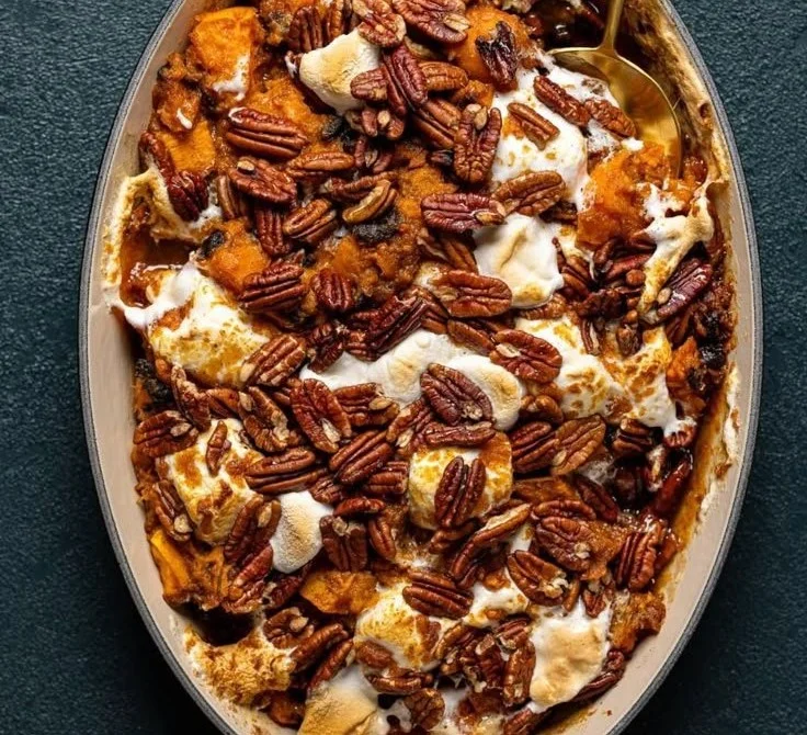 Southern Maple Sweet Potato Casserole topped with pecans and maple syrup.