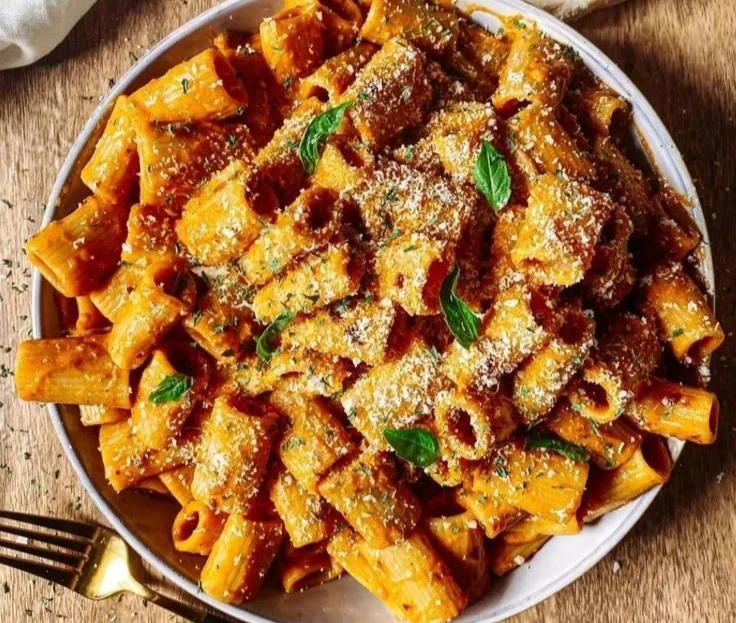 Creamy chili oil pasta garnished with herbs and spices