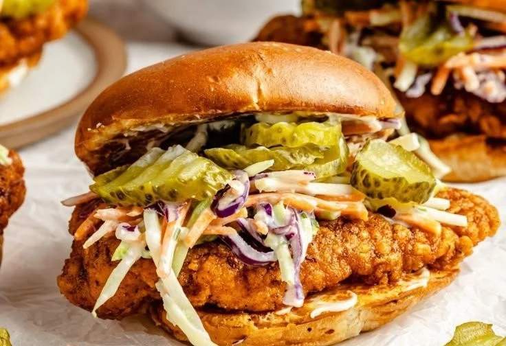 Nashville hot chicken sandwich served with spicy sauce and pickles