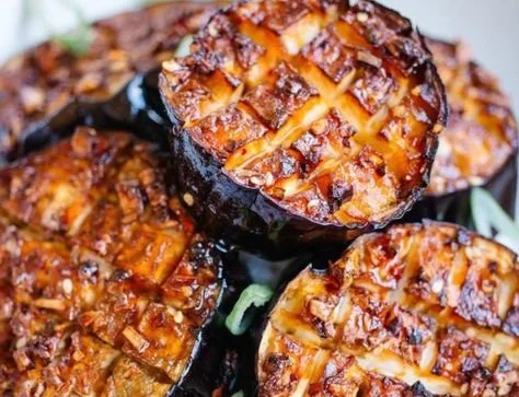Crispy air fryer eggplant slices served on a plate with dipping sauce