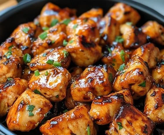 Plate of Air Fryer Teriyaki Chicken garnished with sesame seeds and green onions
