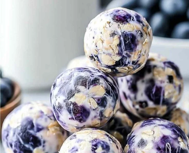 Blueberry cheesecake protein bites on a white plate
