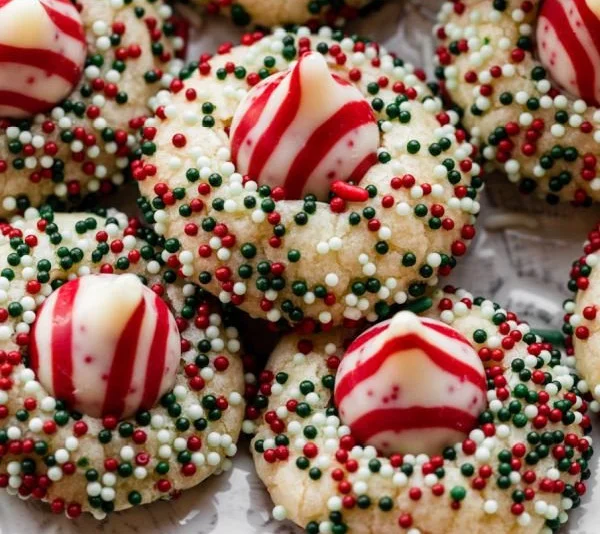 Delicious Candy Cane Kiss Cookies decorated with peppermint and chocolate kisses.