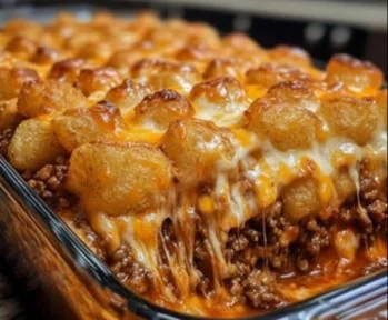 Delicious Chili Cheese Tater Tot Casserole topped with melted cheese and chili
