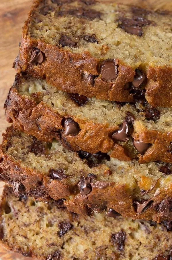 Sliced chocolate chip banana bread on a wooden board