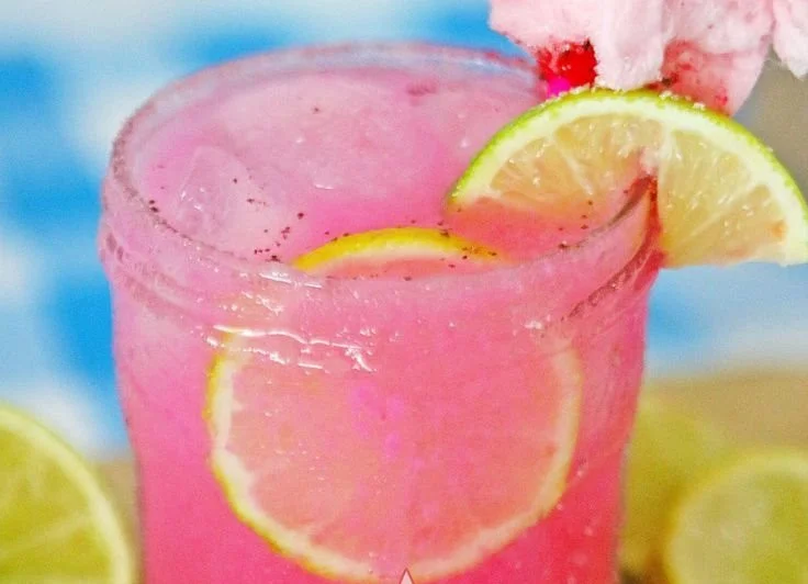 Colorful Cotton Candy Margarita in a glass with fun garnishes