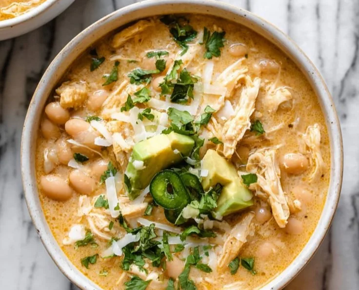 Creamy white chicken chili in a bowl garnished with cilantro