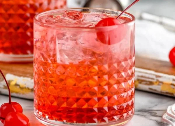 Refreshing Dirty Shirley cocktail garnished with cherries and citrus