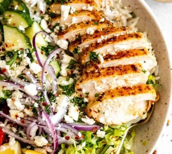 Delicious Greek Chicken Bowl with fresh vegetables and herbs