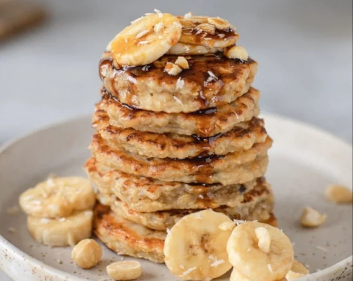 Delicious and fluffy healthy banana oatmeal pancakes served with fresh fruit