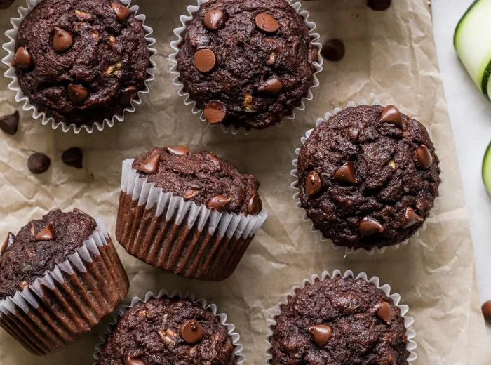Healthy chocolate zucchini muffins fresh out of the oven with chocolate chunks