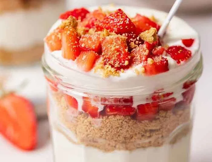 High protein cheesecake jars topped with berries for a healthy dessert