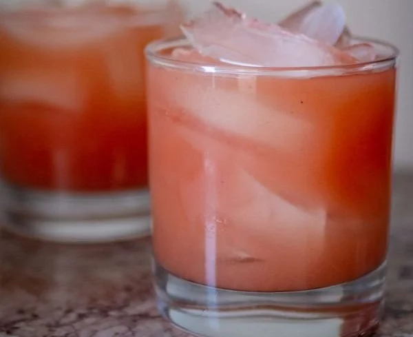 Iced Guava White Tea Lemonade in a glass with garnishes