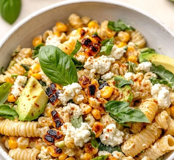 Juicy street corn pasta salad with fresh ingredients in a bowl.