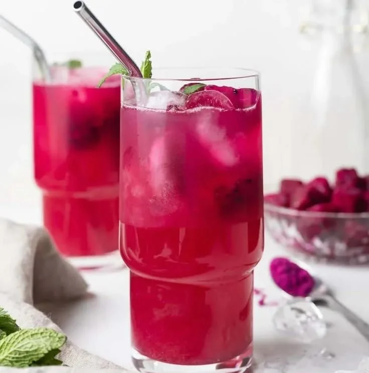 Mango Dragon Fruit Refresher topped with fresh fruit and ice in a glass
