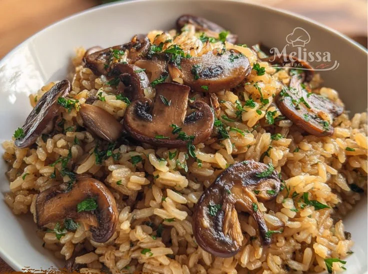 Delicious one-pot soy sauce mushroom rice served in a bowl with fresh herbs.