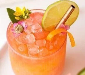 Pineapple Mango Rum Punch in a glass with colorful fruits and garnishes