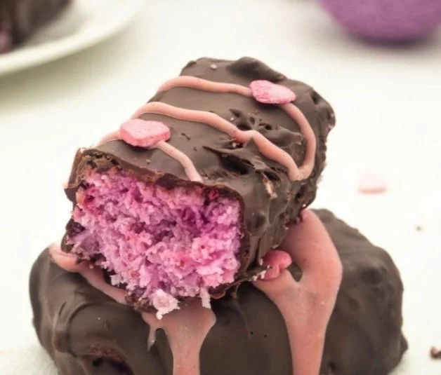 Plate of homemade Raspberry Chocolate Coconut Bars with fresh raspberries