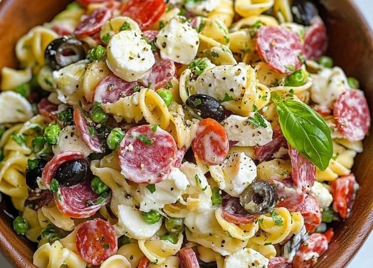Salami and mozzarella tortellini pasta salad with vegetables in a bowl
