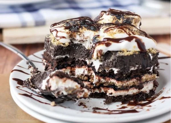 Delicious S'mores Lasagna with layers of chocolate, marshmallow, and graham crackers