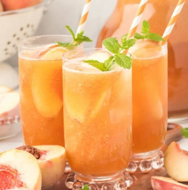 Pitcher of Southern Peach Tea with fresh peaches and mint leaves