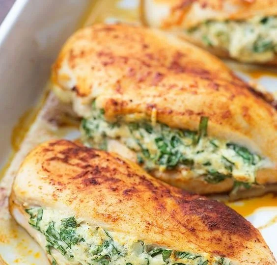 Healthy spinach stuffed chicken breasts served on a plate
