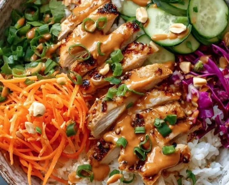 Colorful Thai Peanut Chicken Buddha Bowl with fresh veggies and peanut sauce
