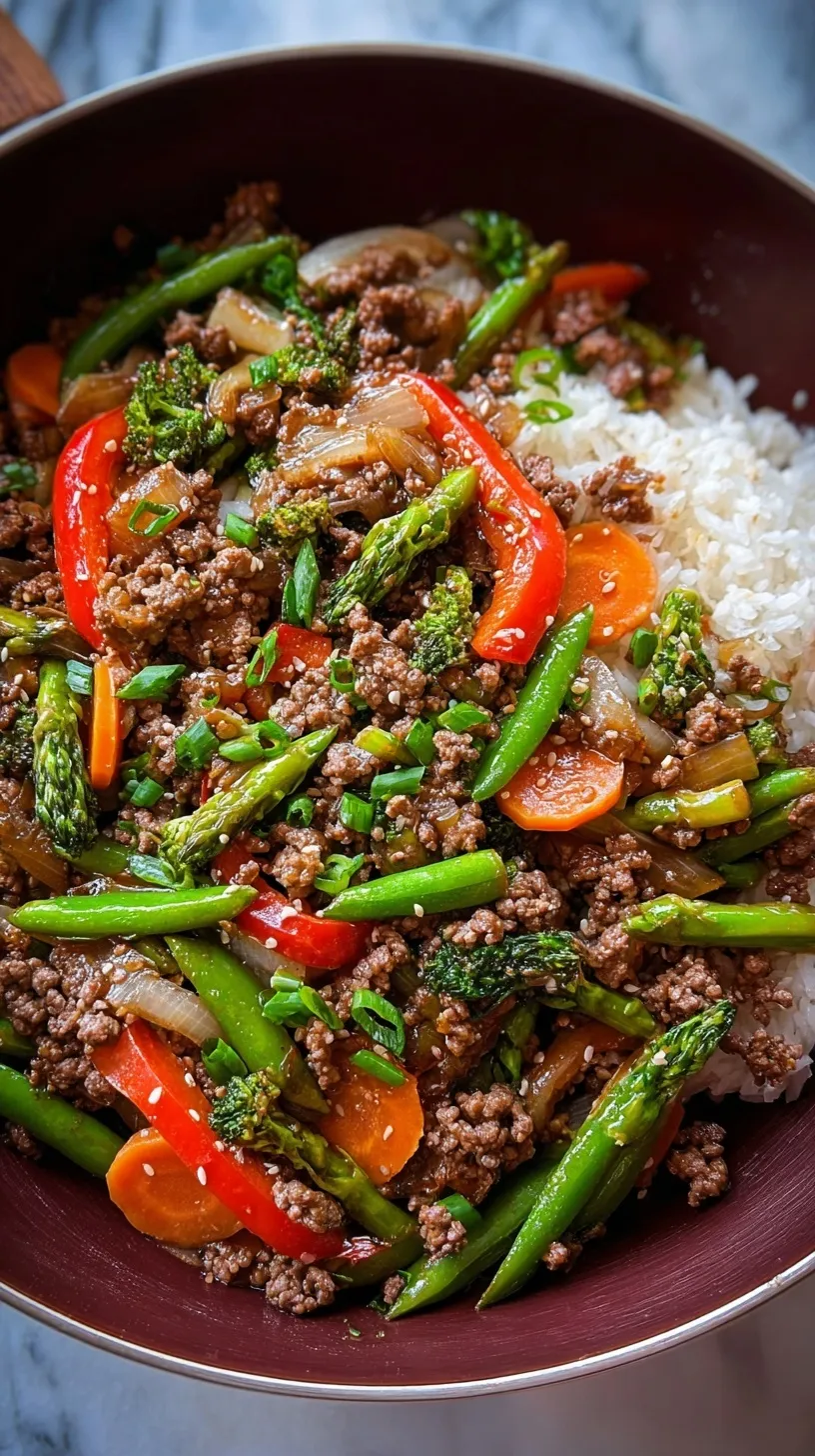 A colorful ground beef stir fry with broccoli, carrots, and peppers in a savory glaze