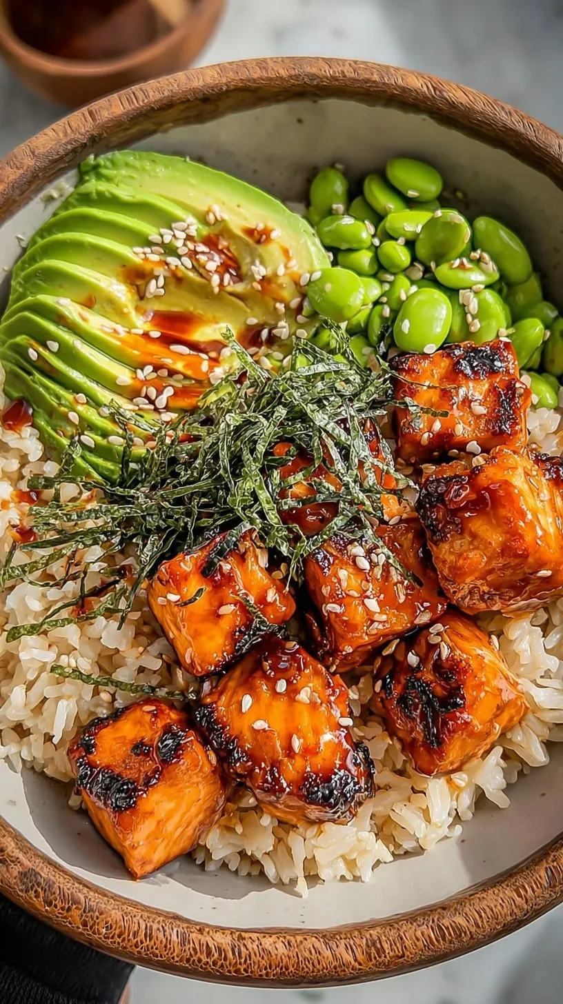 A fresh salmon teriyaki bowl with steamed broccoli, carrots, and sesame seeds over jasmine rice.